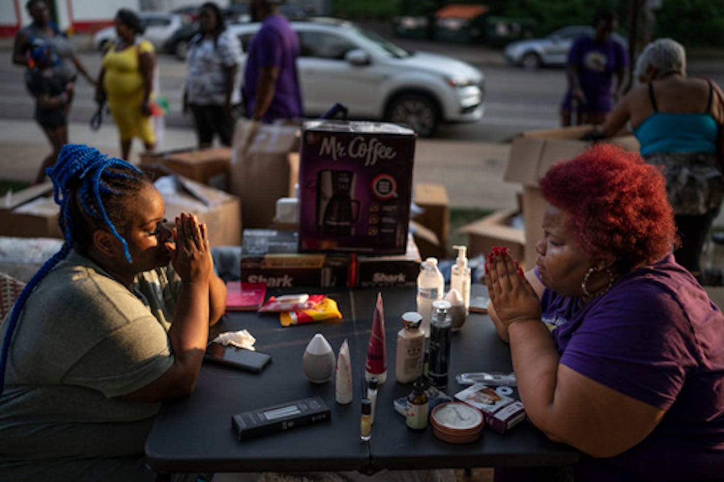 Connie Rhodes, right, of Restoration Incorporated leads Nequisha Bennett through an aromatherapy session during a National Night Out celebration at Parque de Castillo in St. Paul on Tuesday.