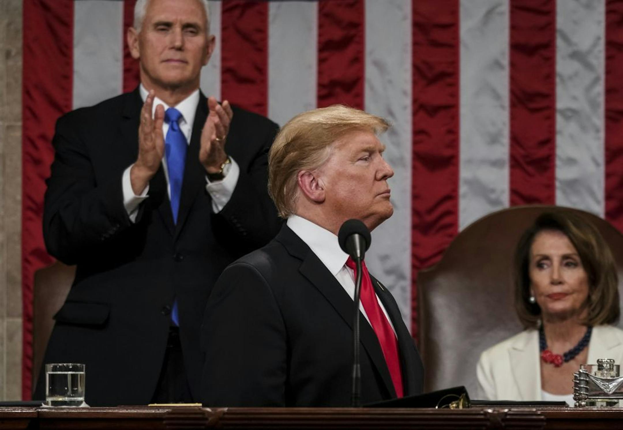 President Donald Trump gives his State of the Union address to a joint session of Congress, Tuesday, Feb. 5, 2019 at the Capitol in Washington, as Vice President Mike Pence, left, and House Speaker Nancy Pelosi look on.