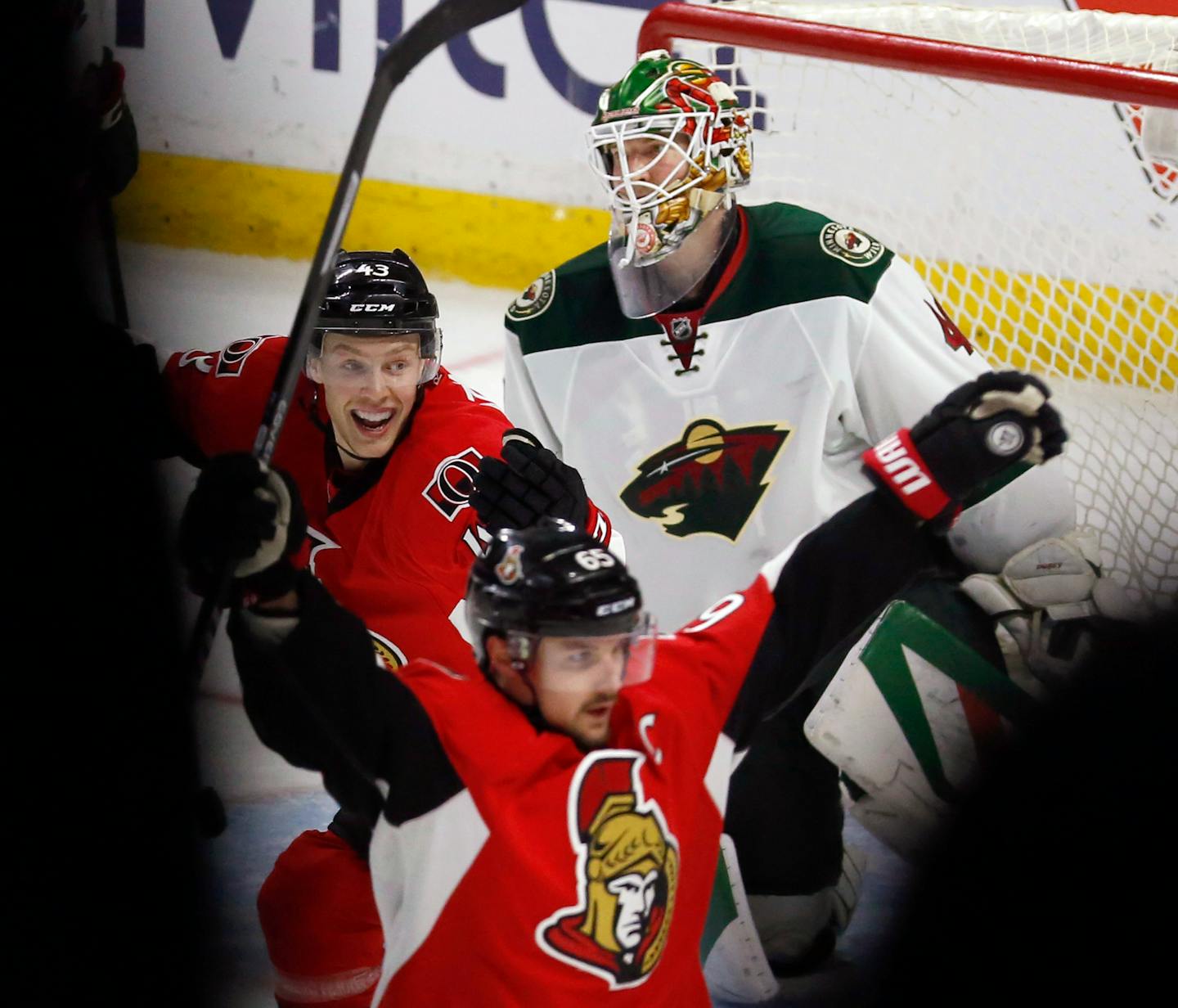 Minnesota Wild goaltender Devan Dubnyk (40) reacts as Ottawa Senators' Erik Karlsson (65) celebrates his overtime goal, in front of teammate Ryan Dzingel (43) during an NHL hockey game Tuesday, March 15, 2016, in Ottawa, Ontario. (Fred Chartrand/The Canadian Press via AP)