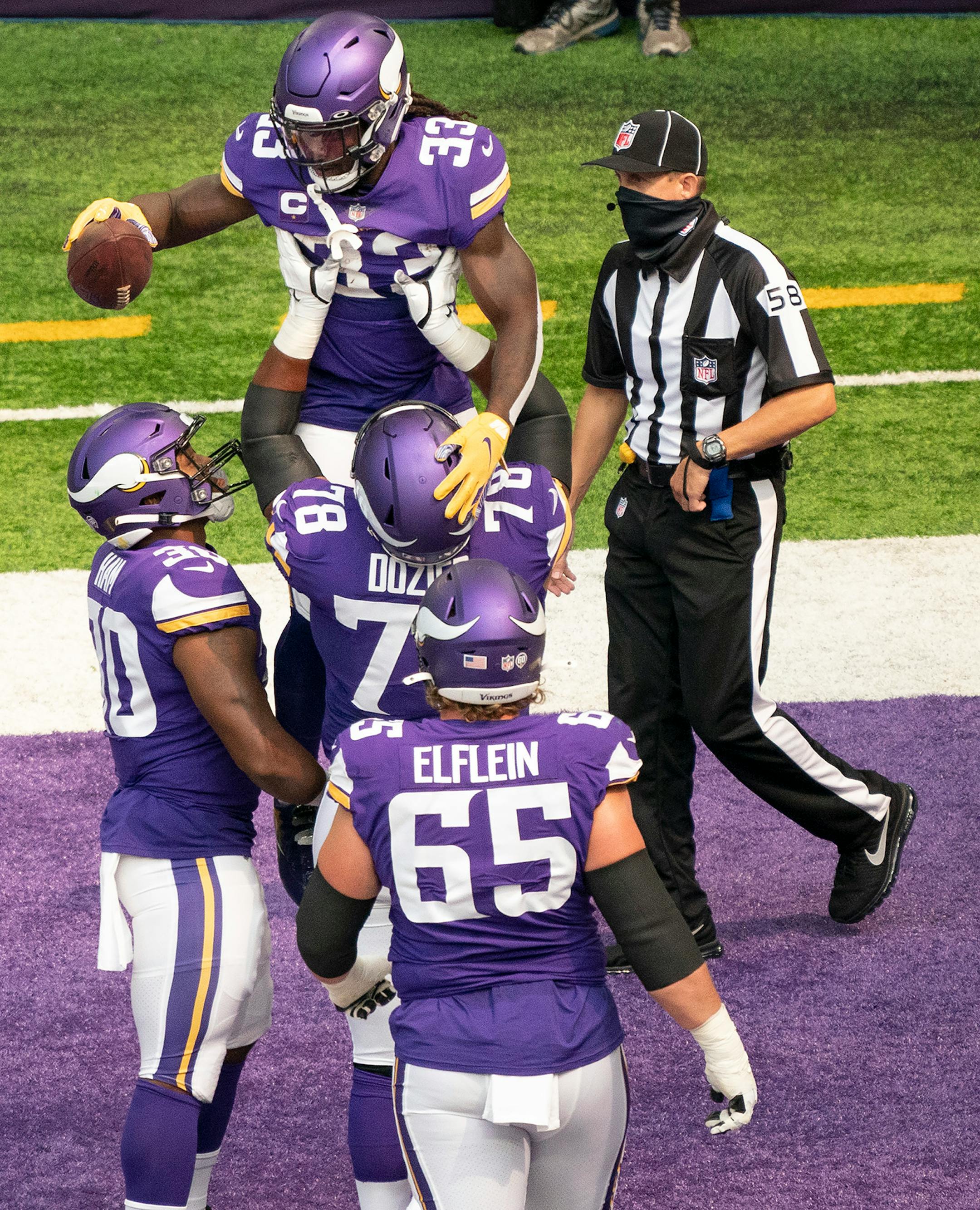 Minnesota Vikings running back Dalvin Cook (33) celebrated his first quarter touchdown run as Minnesota guard Dakota Dozier (78) lifted him.