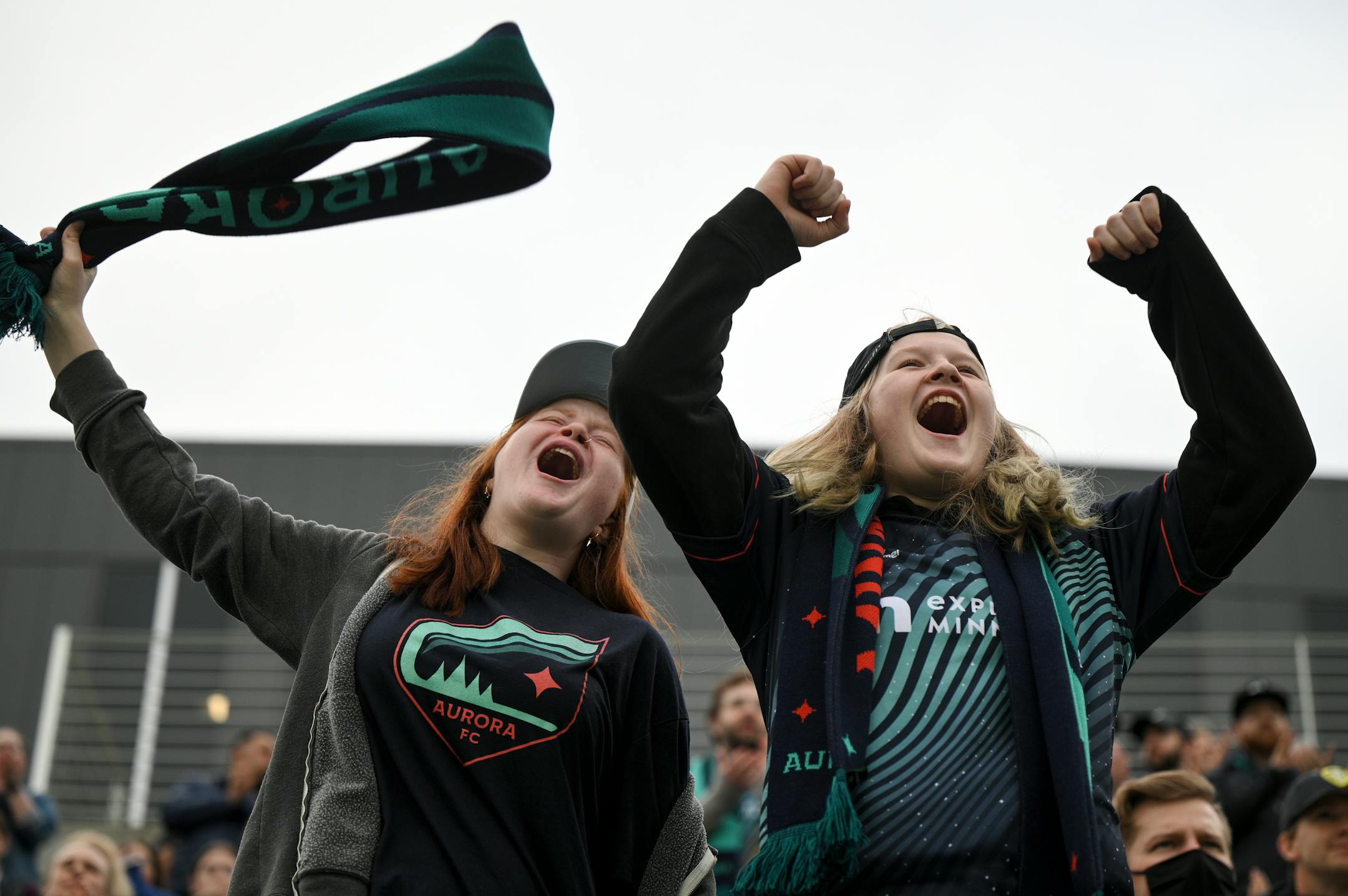 Aurora fans, including Nadia Hinman, left, and her sister Sam cheer for their team before the match.