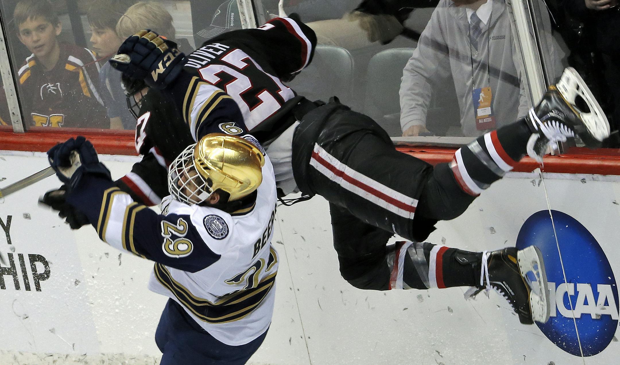 Huskies Nick Oliver (27) and Notre Dame's Jared Beers (29) colided as they skated towards the puck. ] Notre Dame Fighting Irish vs. St. Cloud State Huskies Regional Hockey Tournament. (MARLIN LEVISON/STARTRIBUNE(mlevison@startribune.com)