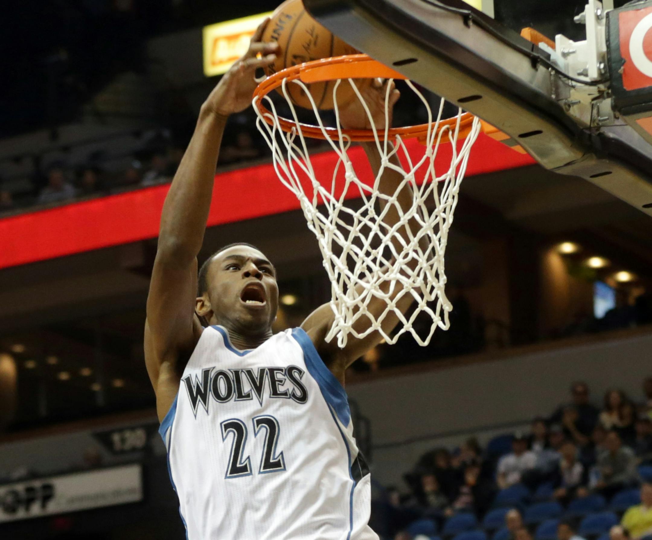 Minnesota Timberwolves rookie Andrew Wiggins dunks in the first quarter of an NBA preseason basketball game against the Philadelphia 76ers, Friday, Oct. 10, 2014, in Minneapolis. Watching, left, is Thaddeus Young. (AP Photo/Jim Mone)