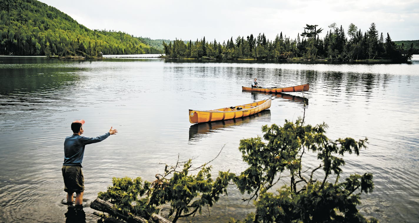 Bob Timmons, left, worked with Aidan Jones to Retrieve a canoe which floated away from the campsite when Aidan took the other canoe out fishing nearby. ] Aaron Lavinsky &#xa5; aaron.lavinsky@startribune.com DAY 1 - Tony Jones, his 14-year old son Aidan , their friend Brad Shannon and Outdoors editor Bob Timmons embarked onto the Voyageurs Highway on Tuesday, June 11, 2019. Their path Tuesday took them from Gunflint Lake, to North Lake, through the Height of Land Portage eventually ending at a ca