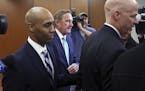 Former Minneapolis police officer, Mohamed Noor, left, leaves the Hennepin County Government Center after a pretrial hearing.