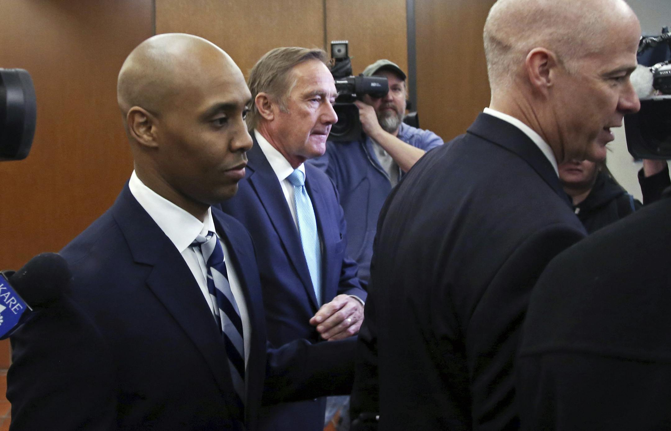 Former Minneapolis police officer, Mohamed Noor, left, leaves the Hennepin County Government Center after a pretrial hearing.