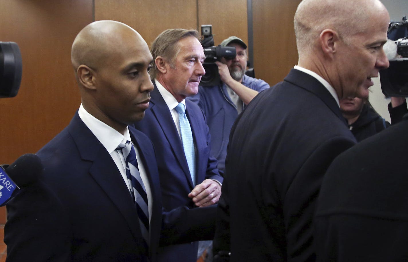 Former Minneapolis police officer, Mohamed Noor, left, leaves the Hennepin County Government Center after a pretrial hearing.