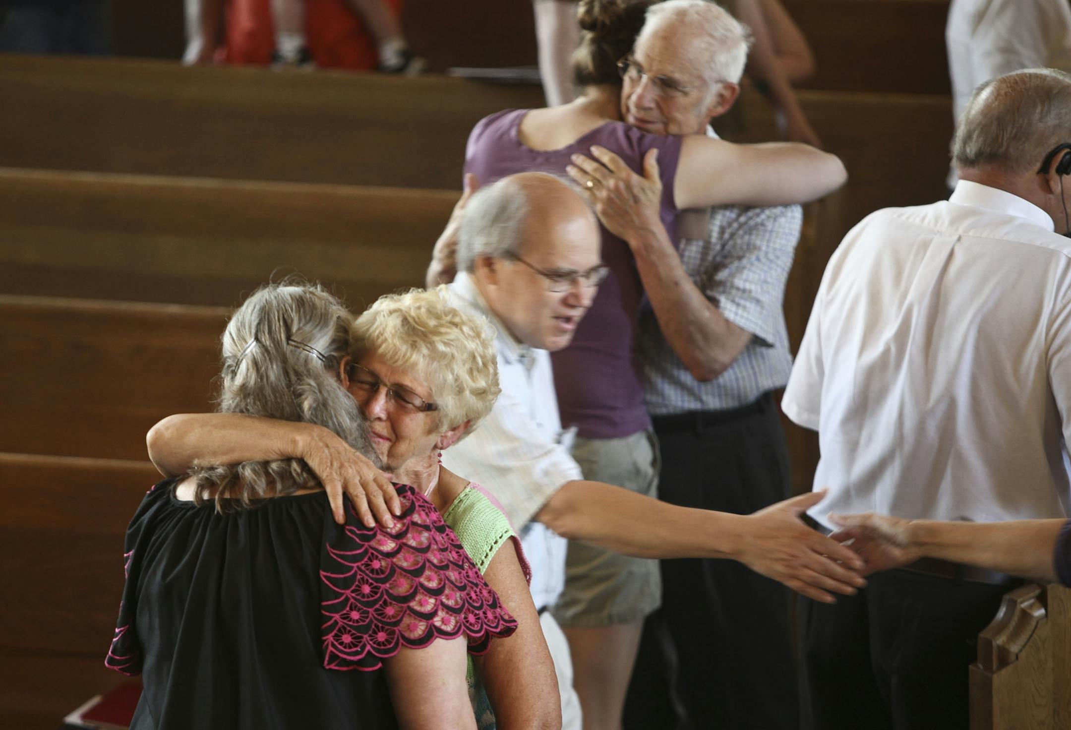Shirely Roy gave a big hug to Jean Lubke as they share peace during the Sunday morning service at University Baptist Church in Minneapolis, Minn., Sunday, September 11, 2011.