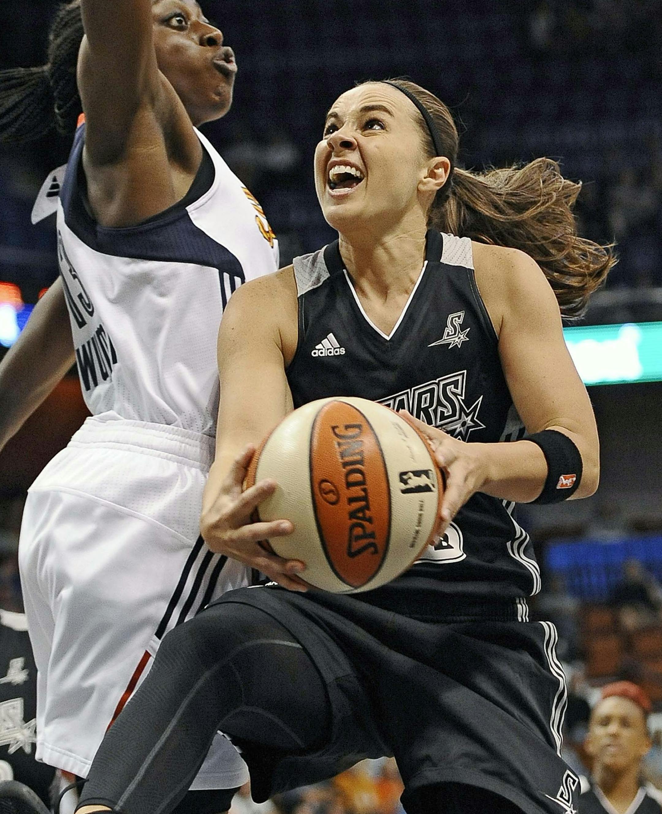 FILE - In this July 1, 2014 file photo, San Antonio Starsí Becky Hammon, right, drives to the basket as Connecticut Sunís Chiney Ogwumike, left, defends during the second half of a WNBA basketball game in Uncasville, Conn. The Stars 16-year WNBA veteran Becky Hammon will retire at the conclusion of the 2014 WNBA season, the team announced Wednesday, July 23, 2014. Hammon will end her career as the Stars all-time leader in assists, points per game and three-point field goals made.(AP Ph