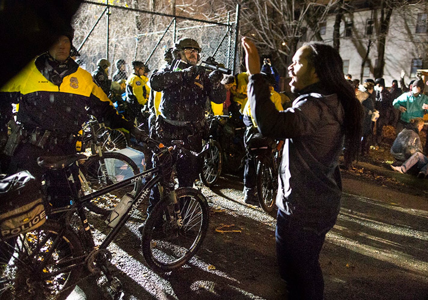 Police aimed (I think mace) at protesters at the west entrance at the fourth precinct on Wednesday, November 18, 2015, in Minneapolis, Minn. ] RENEE JONES SCHNEIDER • reneejones@startribune.com Black lives matter. Jamar Clark