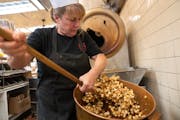 Brenda Lamb, owner of Candyland, mixed a fresh batch of caramel popcorn on Oct. 20, 2023, in St. Paul.