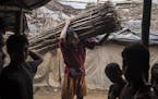 A Rogingya worker carries wood at the Kutupalong Refugee Camp in Teknaaf, Bangladesh, June 16, 2015. In 1992, hundreds of thousands of ethnic Rohingya
