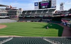 Grounds crew members prepare Target Field for the April 8 home opener