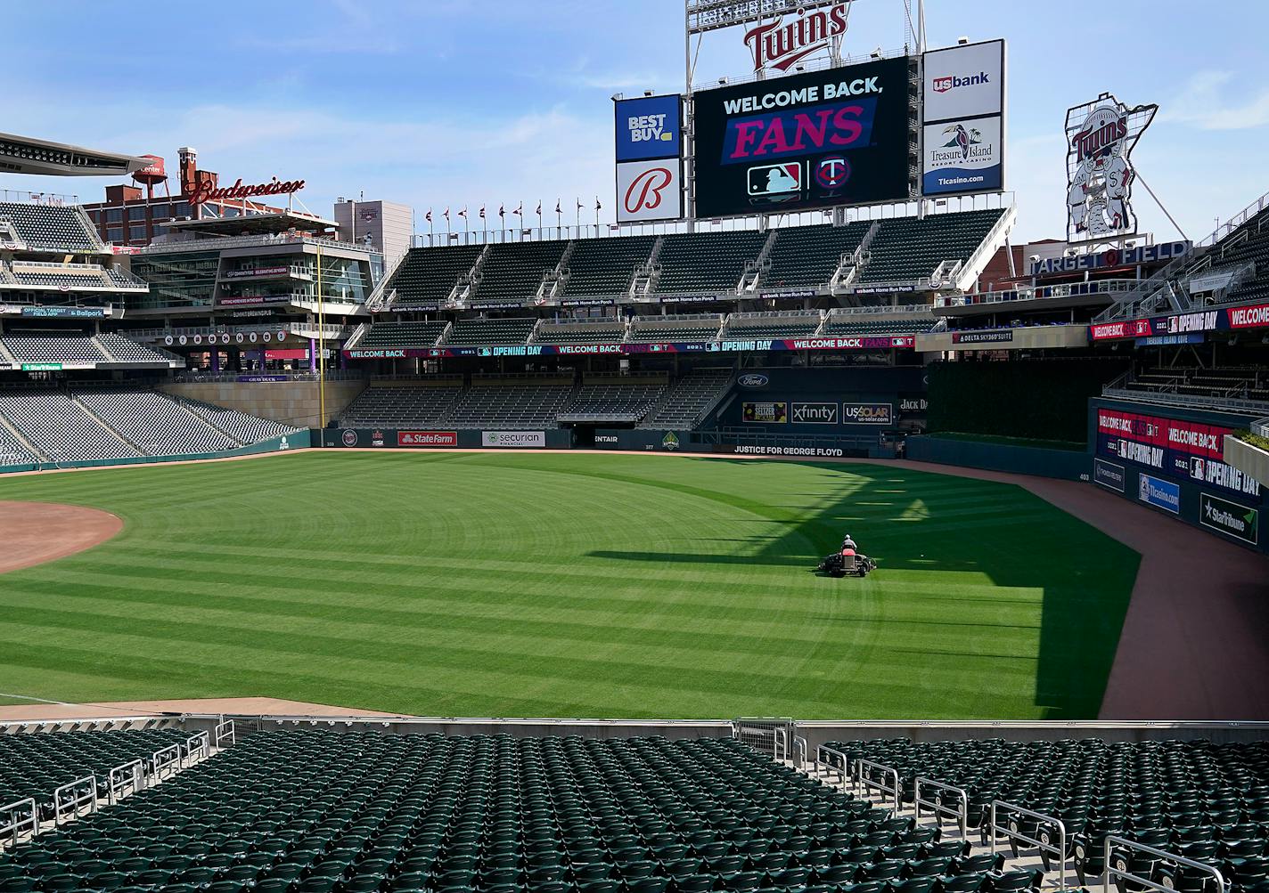 Grounds crew members prepare Target Field for the April 8 home opener