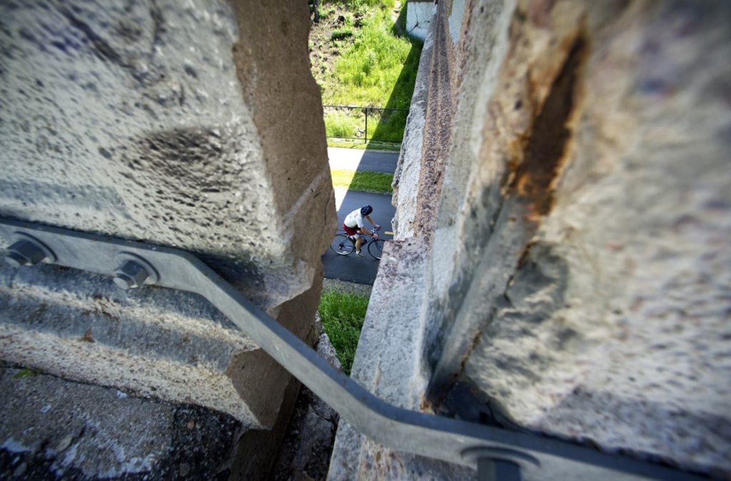 Concrete has chipped away exposing rusting reinforcement bars under Fremont Ave. S. one block north of Lake St in Uptown. A huge crack can be seen in the north wall. The bridge goes over a bicycle greenway. It is on the list of deficient bridges put out by Transportation for America. Wednesday, June 19, 2013