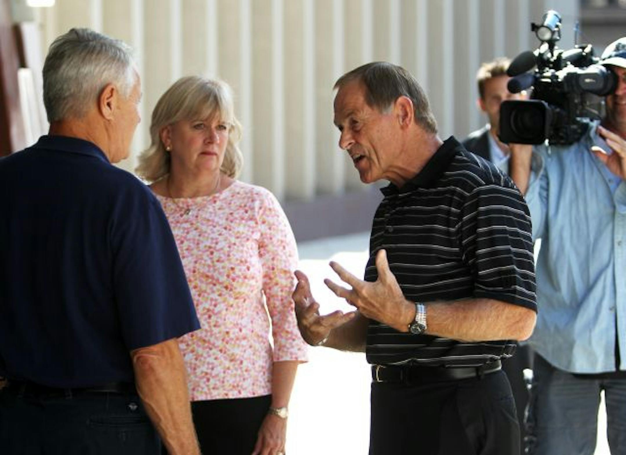 Trevor Cook victims Mike and Mary Patterson of Walford, IA, right to left, and Hieko Reske of Denton, TX, vent outside the U.S. Courthouse after Trevor Cook was sentenced to 25 years in prison. The Pattersons were among hundreds who lost large sums of money to Cook. "It takes away a lot of our options," Mike said. "We live lighter." He also said, "I'm ready to move on." Reske lost more than $700,000 to Cook.