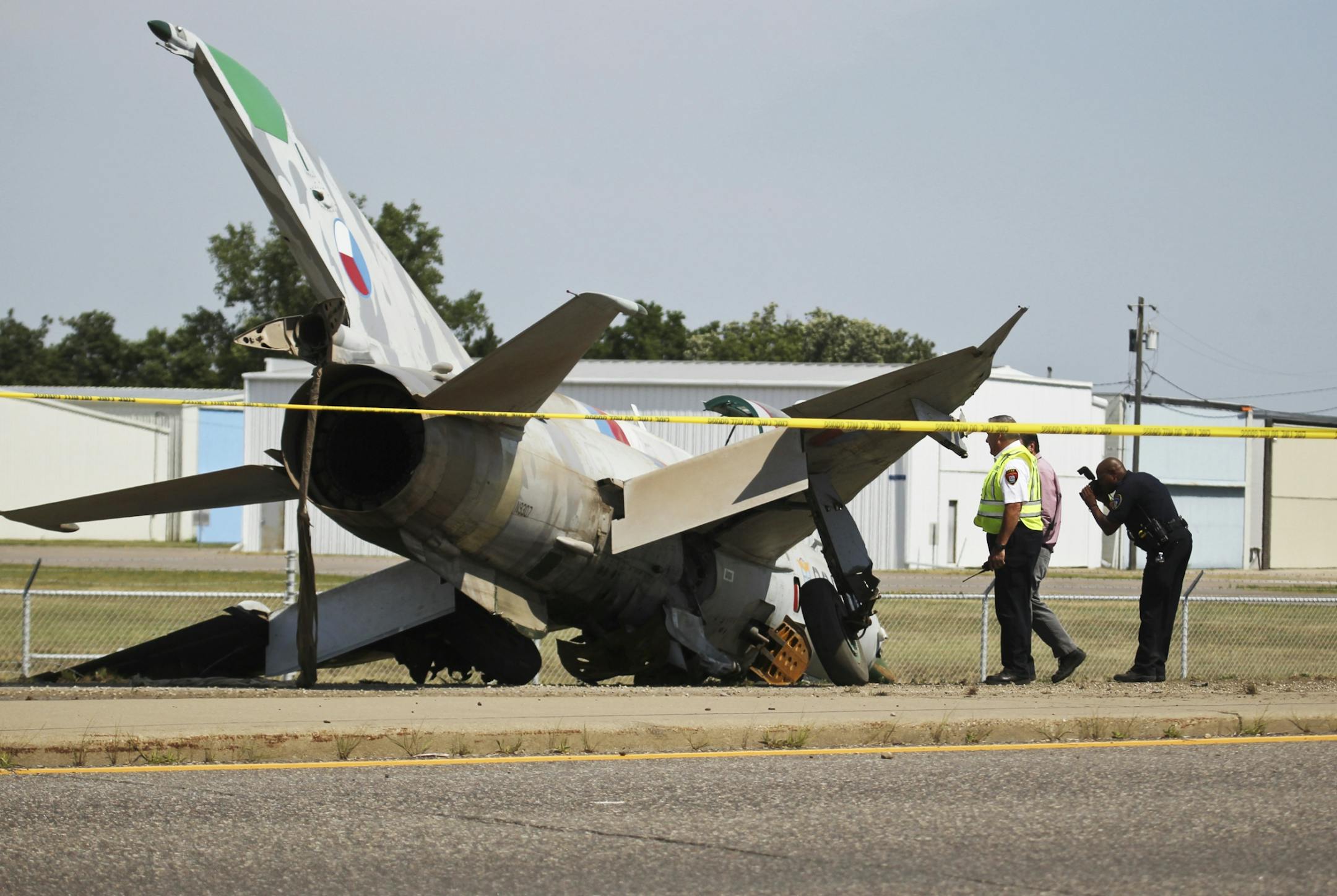 The crashed Russian MiG is photographed and inspected by authorities along Flying Cloud Road near Pioneer TrailThursday, July 12, 2012, in Eden Prairie, MN.
