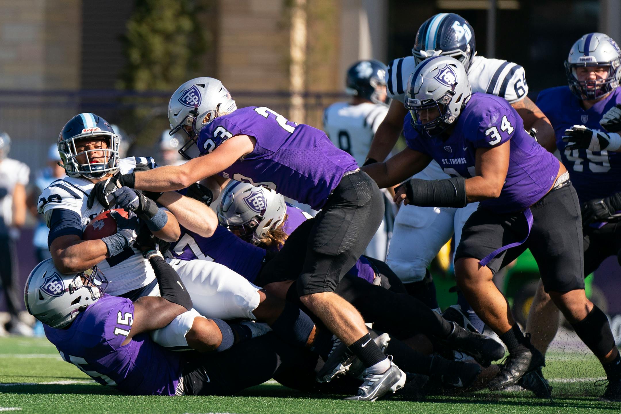 San Diego Toreros running back Chris Childers (28) is swarmed by St. Thomas defenders in the second quarter Saturday, Oct. 29, 2022 at O'Shaughnessy Stadium in St. Paul, Minn.