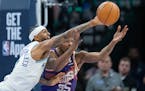 Wolves guard Nickeil Alexander-Walker knocks the ball away from Suns forward Kevin Durant on Saturday at Target Center.