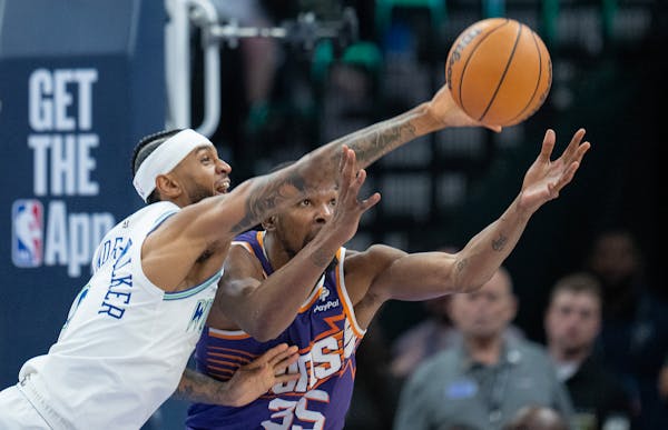 Wolves guard Nickeil Alexander-Walker knocks the ball away from Suns forward Kevin Durant on Saturday at Target Center.