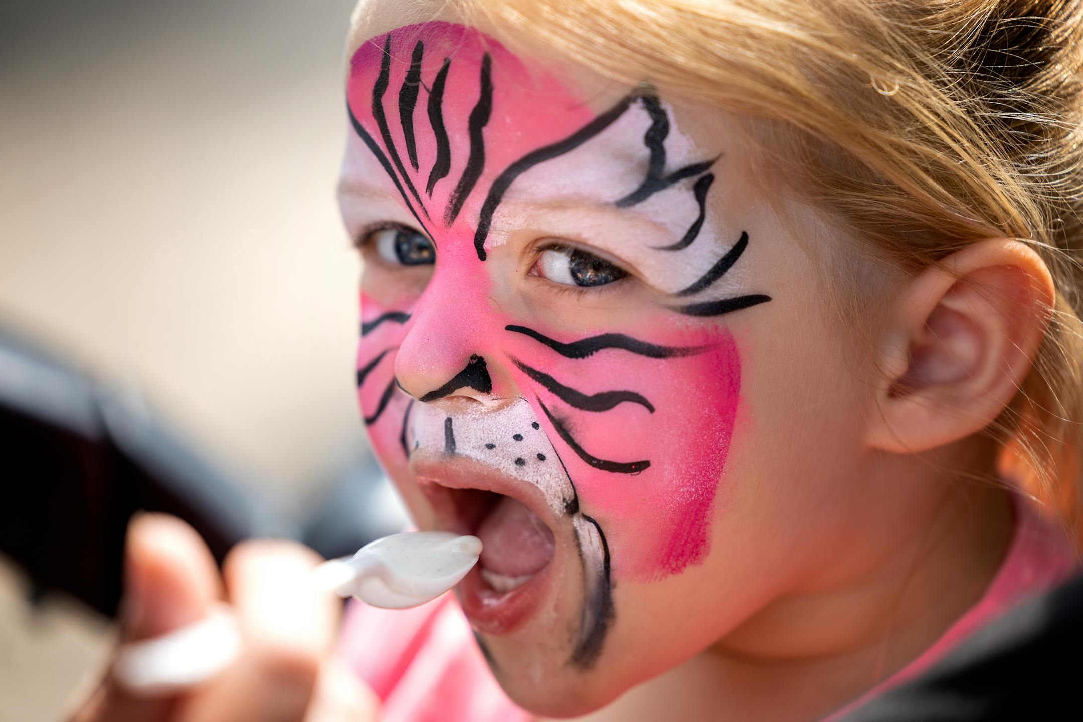 Jessie Leuer of Oakdale fed ice cream to her daughter Zelda, 3, Thursday,. August 25, 2022, at The Minnesota State Fair.