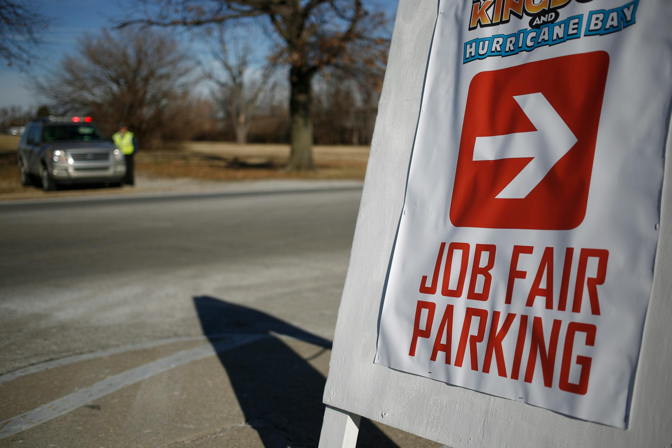 An arrow points to parking for a job fair held by Kentucky Kingdom amusement park to hire seasonal summer workers in Louisville, Kentucky, U.S. on Saturday, Jan. 4, 2014. Companies added more workers than projected in December as U.S. employers grew more optimistic about the prospects for demand, a private report based on payrolls showed Jan. 8. Photographer: Luke Sharrett/Bloomberg