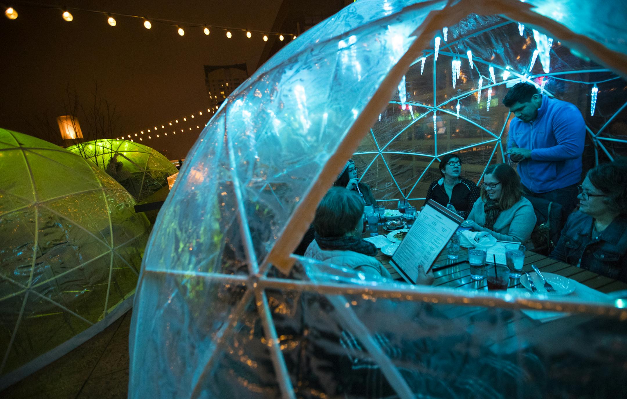Server Peter Tazin took an order from Mayo colleagues, from the left, Brenda Luther, Michelle Luhman, Hannah Wright, Jean Fox, Stacy Weelborg and Ruth Grimm in an igloo on the rooftop at La Vetta on Wednesday, January 10, 2018, in Rochester, Minn. ] RENEE JONES SCHNEIDER • renee.jones@startribune.com