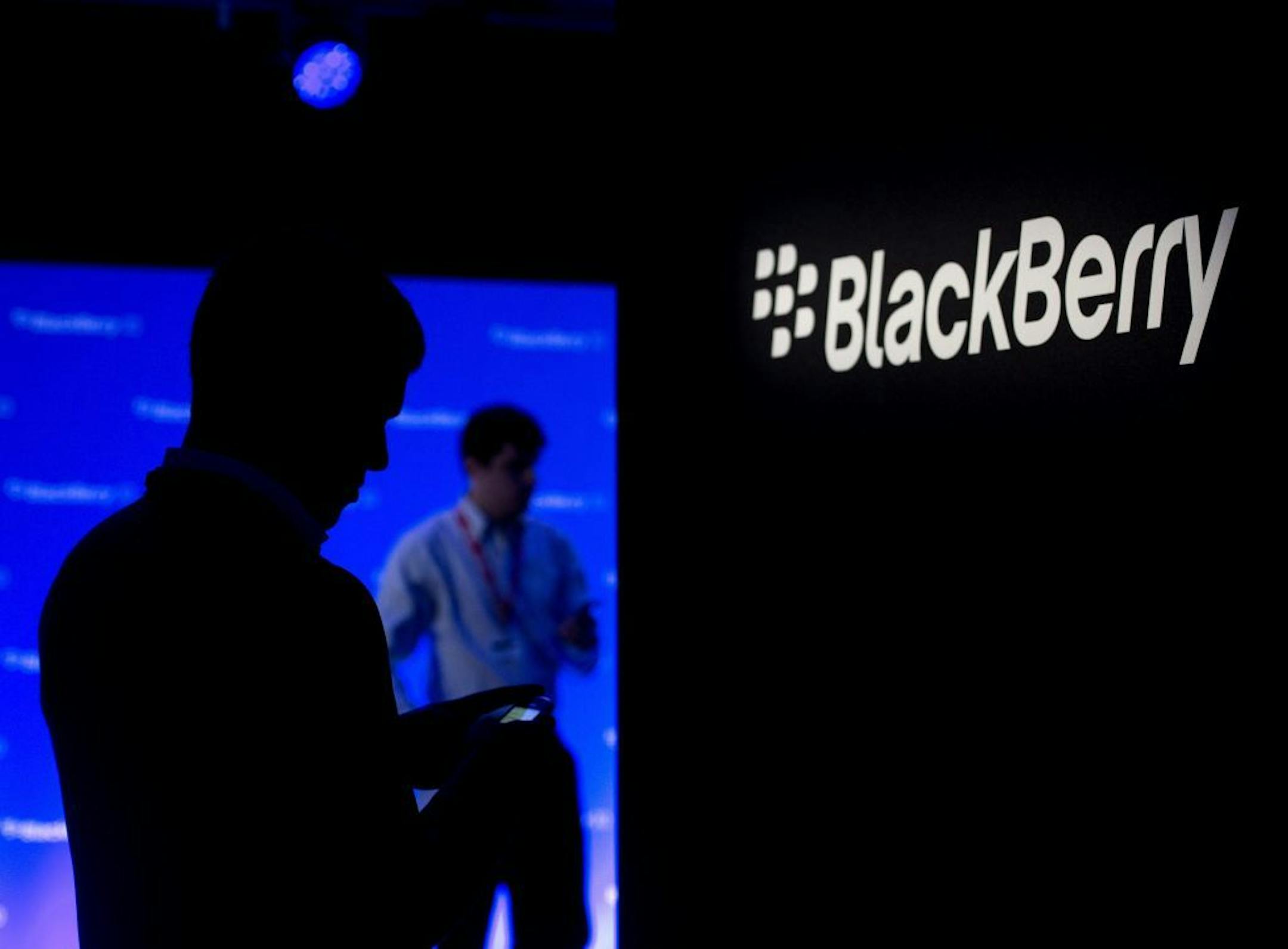 People use their Blackberries as they wait for the Blackberry BB10 launch in Toronto on Wednesday, Jan. 30, 2013.