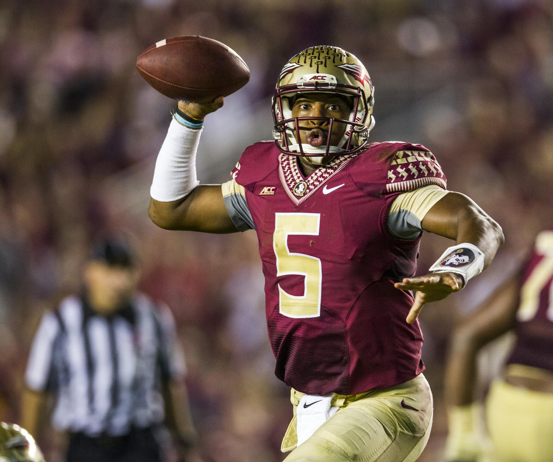 Florida State quarterbacks rolls out to pass in the second half of an NCAA college football game against Notre Dame in Tallahassee, Fla., Saturday, Oct. 18, 2014.Florida State defeated Notre Dame 31-27. (AP Photo/Mark Wallheiser)