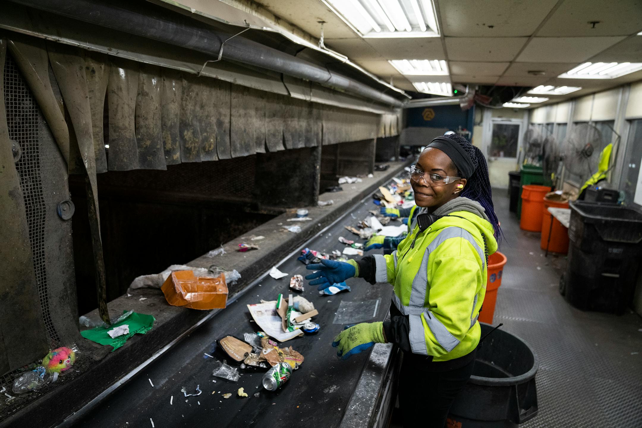 Shalisha Edwards, a line sorting lead, sorts recycling materials inside the single stream recycling facility at Dem-Con Companies Environmental Campus.