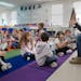 Spanish immersion teacher Marita Schmitz does the itsy-bitsy spider with her kindergarten students at the St. Cloud school district’s Clearview Elem