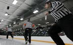 Hockey referees Jerry McLaughlin, Joel Lombard and Josh Lupinek, took the ice before a game between Edina and Maple Grove High school at Braemar Arena