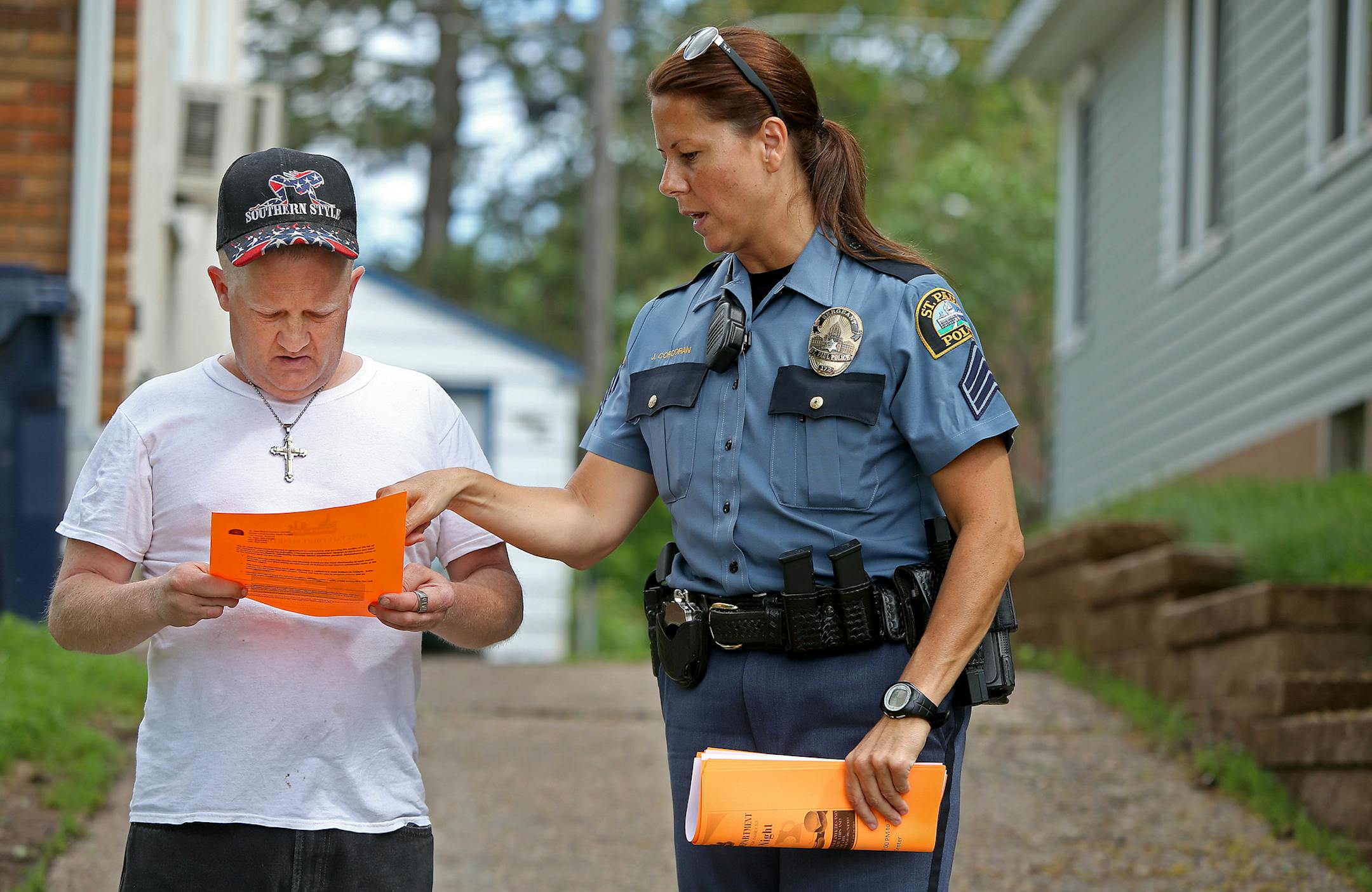 St. Paul Police Sergeant Jennifer Corcoran spoke with David Thomas Winter outside his home on the East Side of St. Paul, MN, Monday, June 2, 2014. She and three of her officers gave out flyers to residents for the first Safe Summer Nights program, which will consist of BBQ block parties with police each week during the summer. ] (ELIZABETH FLORES/STAR TRIBUNE) ELIZABETH FLORES • eflores@startribune.com