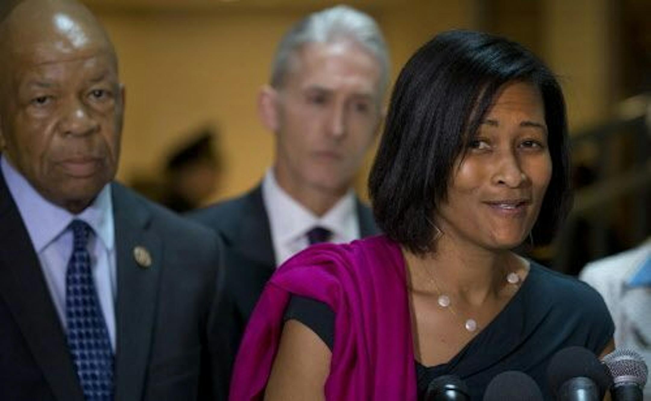Cheryl Mills, a longtime lawyer and aide for Hillary Rodham Clinton, and Rep. Elijah Cummings (D-Md.), a member of the House Benghazi committee, speak to reporters after a private meeting of the committee on Capitol Hill in Washington, Sept. 3, 2015. Rep. Trey Gowdy (R-S.C.) is at rear.