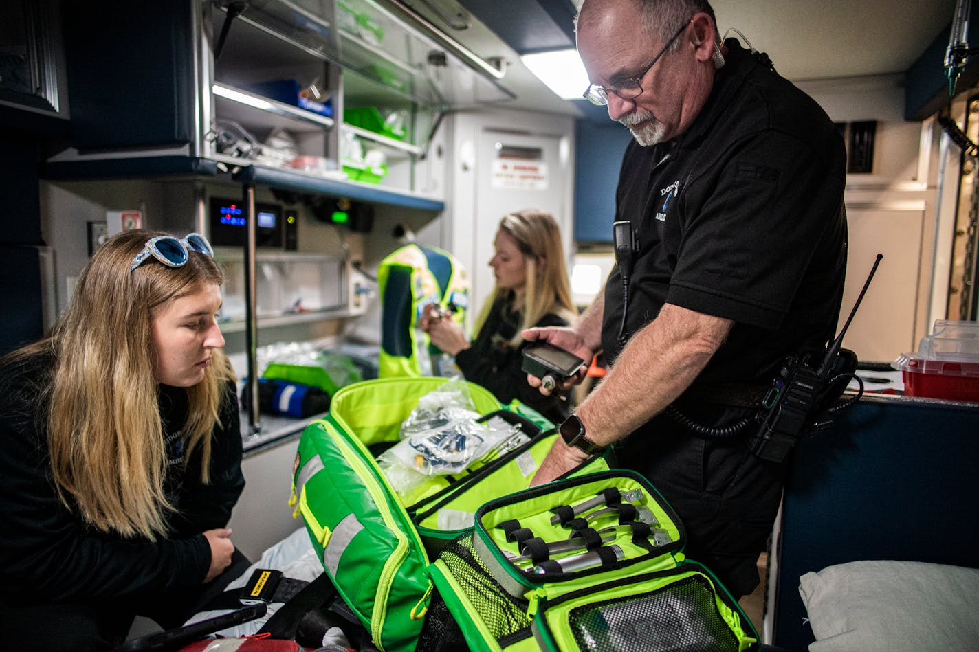 EMT Elise Braswell works with paramedic John Fox to inventory supplies on an ambulance ready to go in service at the Dodge Center Ambulance Service in Dodge Center, Minn., on Thursday, Oct. 20, 2022. Ambulance services across Minnesota are suffering from staffing and volunteer shortages, funding issues and potential closures. ] RICHARD TSONG-TAATARII • richard.tsong-taatarii@startribune.com