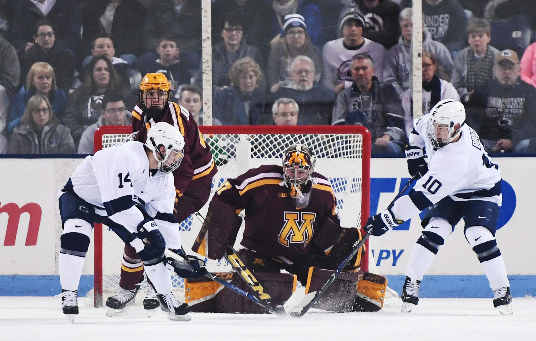 Minnesota’s goaltender Eric Schierhorn (center) stops a shot by Penn State’s Brandon Biro (10). Penn State’s Nate Sucese waits for a rebound during Saturday’s Big Ten Quarterfinals Game 2 at Univesity Park, Pa. Penn State defeated Minnesota, 6-5. (Photo by Steve Manuel)