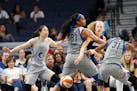 Atlanta Dream center Marie Gulich passes the ball between the Lynx's Alaina Coates and Asia Taylor during a game on July 2