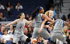 Atlanta Dream center Marie Gulich passes the ball between the Lynx's Alaina Coates and Asia Taylor during a game on July 2
