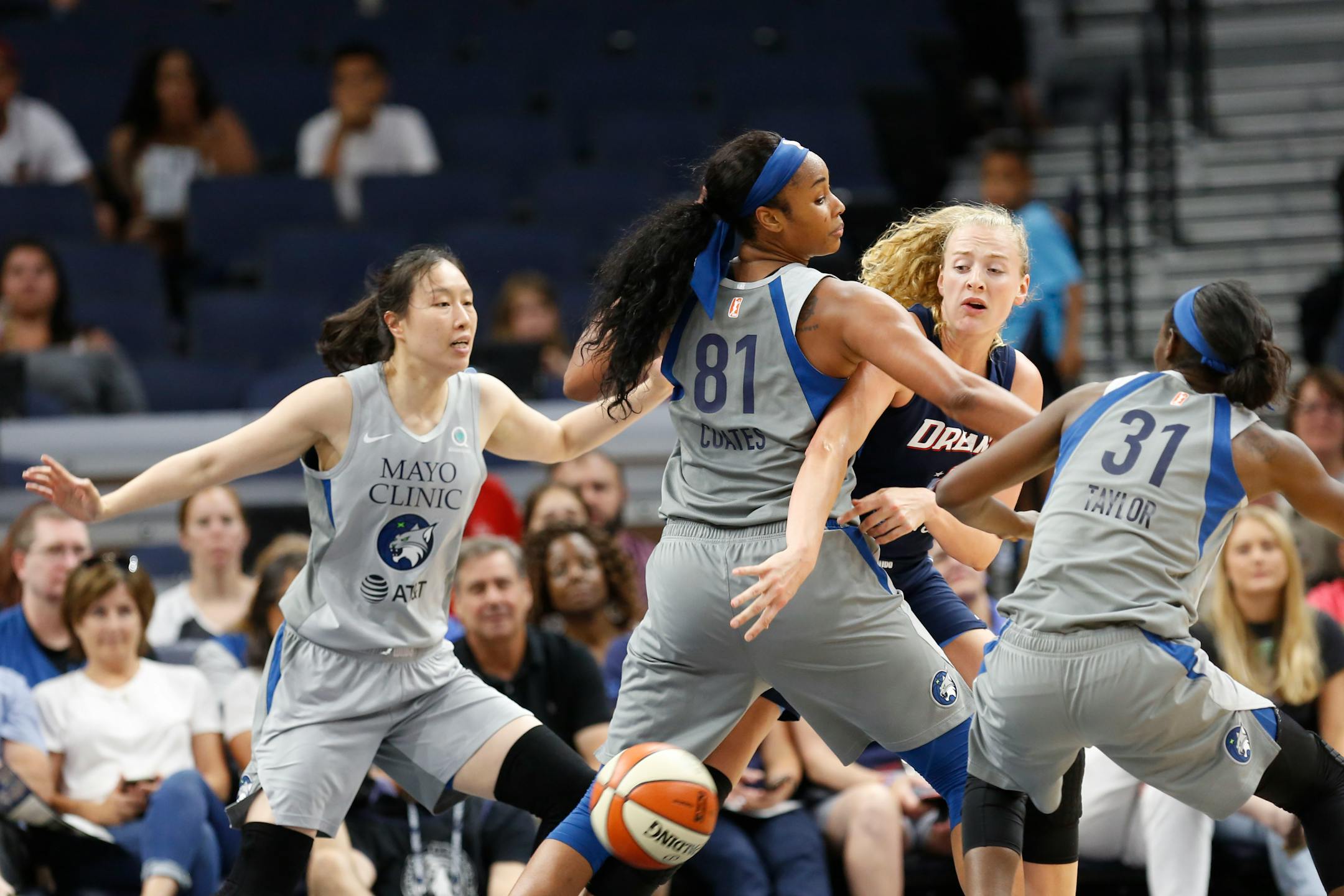Atlanta Dream center Marie Gulich passes the ball between the Lynx's Alaina Coates and Asia Taylor during a game on July 2