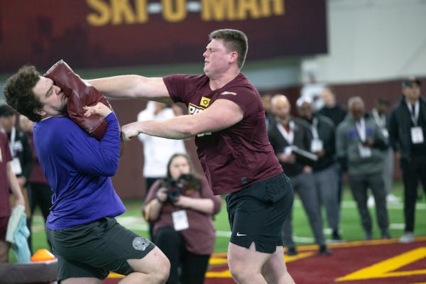 John Michael Schmitz, right, worked out for NFL scouts at the Gophers’ pro day last month.