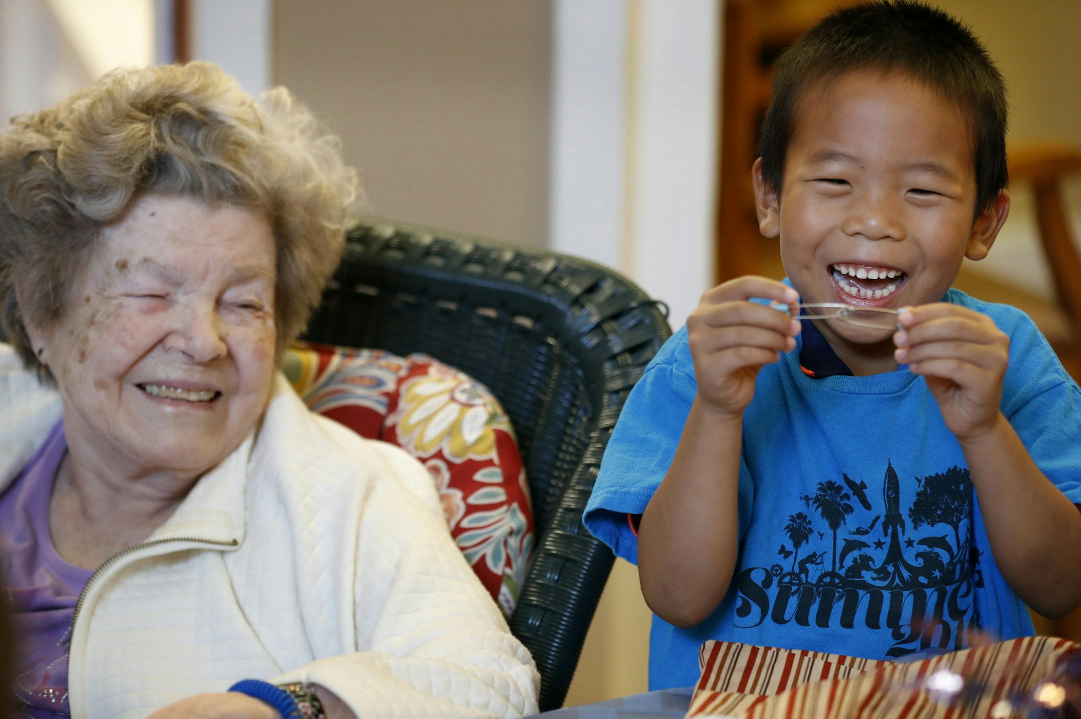 Ninety-five year old Irma a resident at Brookdale Senior Living reacts to Christopher Xu 6, after he showed her safety pins during a visit Wednesday August 17, 2016 in North Oaks, MN.] A new partnership between Kindercare and Brookdale Senior Living is bringing elementary kids on monthly visits to see seniors with Alzheimer's Jerry Holt / jerry.Holt@Startribune.com