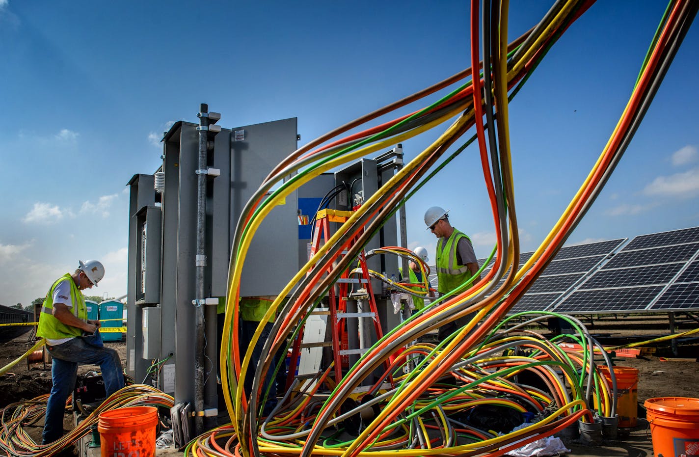 Workers complete wiring at a large solar project at the Blue Lake Wastewater Treatment Plant in Shakopee. ] GLEN STUBBE * gstubbe@startribune.com Thursday September 3, 2015 Workers are completing a large solar project at the Blue Lake Wastewater Treatment Plant in Shakopee that will supply electricity to it and a fertilizer operation. This is one of four solar projects in the works at the Metropolitan Council. The others are shared-solar projects called community solar gardens. This one is not a