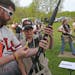 (left to right) Lakeville South High School Trap Shooting Team Head Coach Jason Kelvie helped Zac Olson, 7th grade, with a jammed round, during trap s