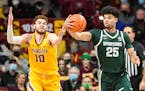 Gophers forward Jamison Battle, left, and Michigan State guard Malik Hall reached for a rebound in a Dec. 8 game at Williams Arena, won by the Spartan