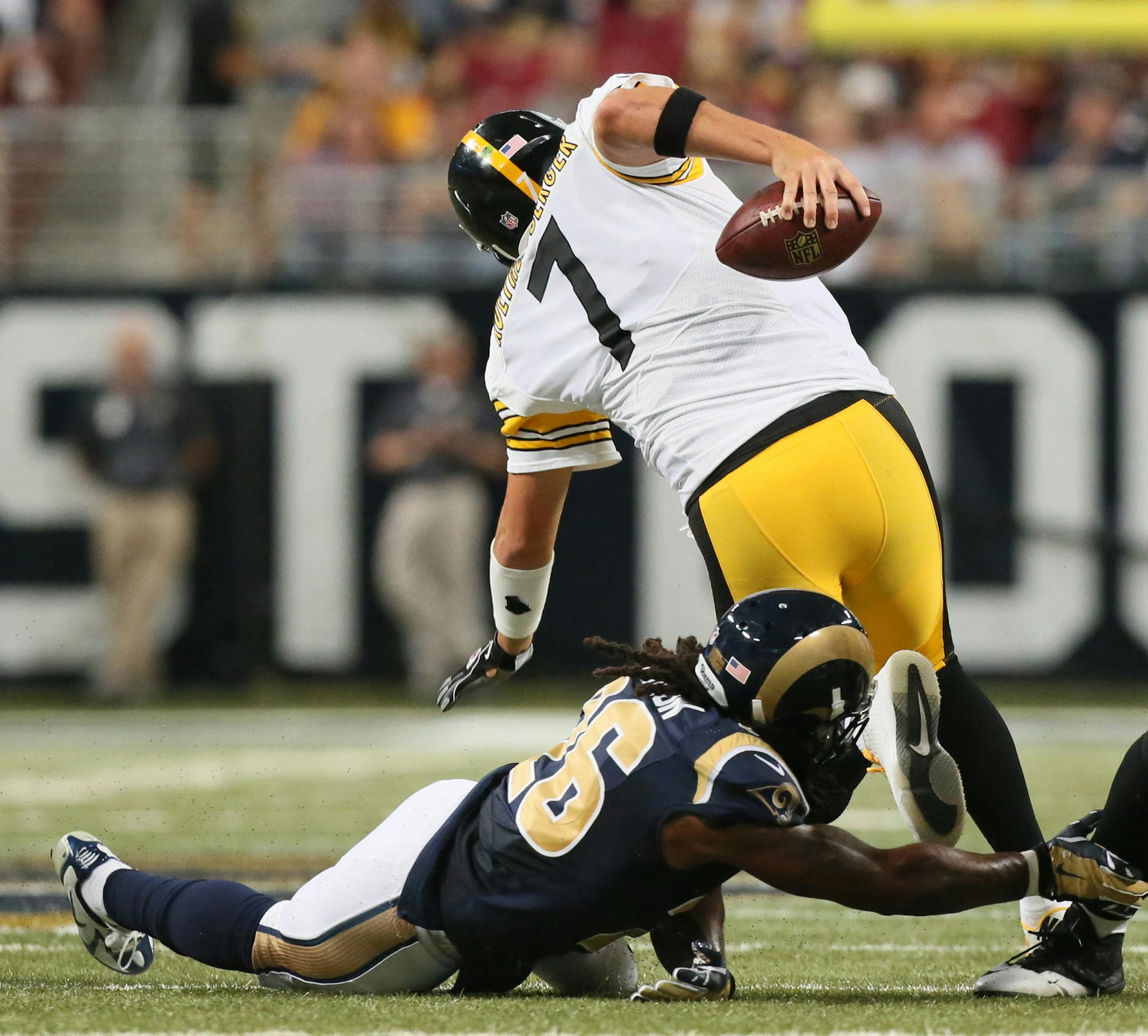 Pittsburgh Steelers quarterback Ben Roethlisberger is tripped up by St. Louis Rams safety Mark Barron for a five-yard sack during third quarter action on Sunday, Sept. 27, 2015, at Edward Jones Dome in St. Louis. (Chris Lee/St. Louis Post-Dispatch/TNS)