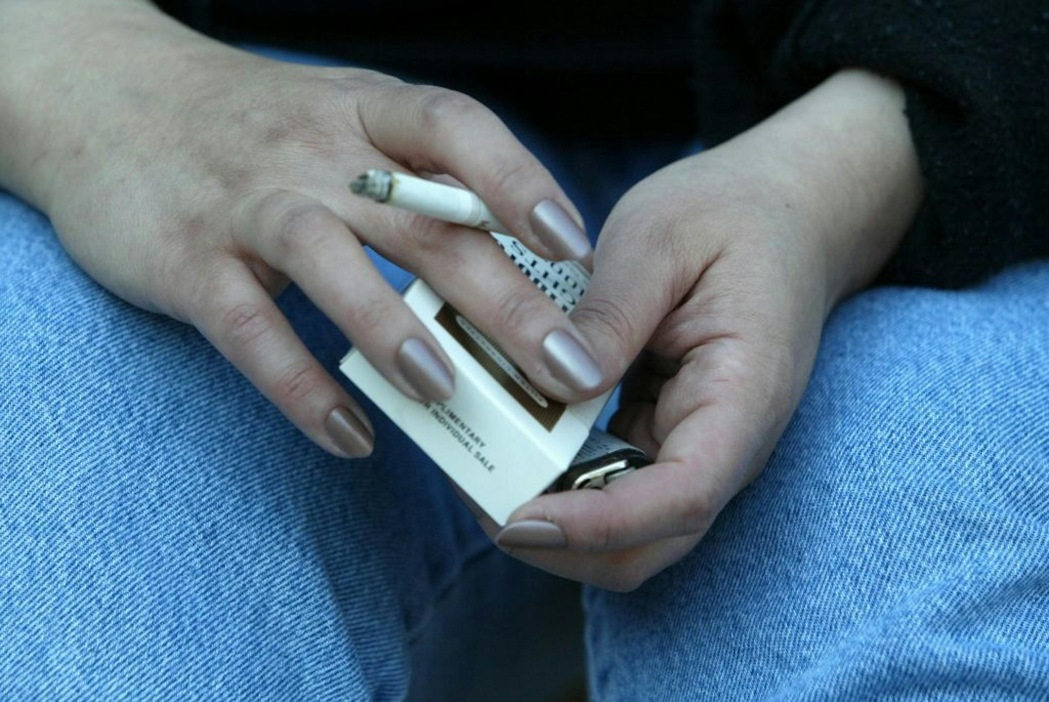 Rochester, MN. 4/19/02--Kristen Romano smoked her last two cigarettes as she prepared to go to the residential nicotine dependence/smoking sesation program at Mayo. The entire group of 10 residents were out enjoying the last cigarette they may ever smoke again. At 4:30 on a recent Friday afternoon each client had to drop their remaining cigarettes and lighters into a red plastic bag and quit smoking as they prepared for a week of intensive lecture and behavior modification programs.