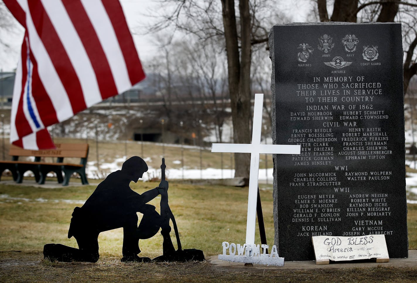 A cross was removed from a kneeling soldier at the veterans memorial park in Belle Plaine, MN. Advocates for the cross have been placing new ones at the park and guarding them throughout the day. ] CARLOS GONZALEZ cgonzalez@startribune.com - January 24, 2017, Belle Plaine, MN, A group of flag-toting Belle Plaine residents has taken it upon themselves to keep guard over the small town's veteran's memorial, rebelling against city's decision to remove a cross from a fallen soldier's grave marker.