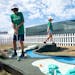 Mason Williams,10, left, plays on the 3M Open Mini Golf Course made out of 3M brand materials like tape and post-it notes with Hazel Grant, 9.