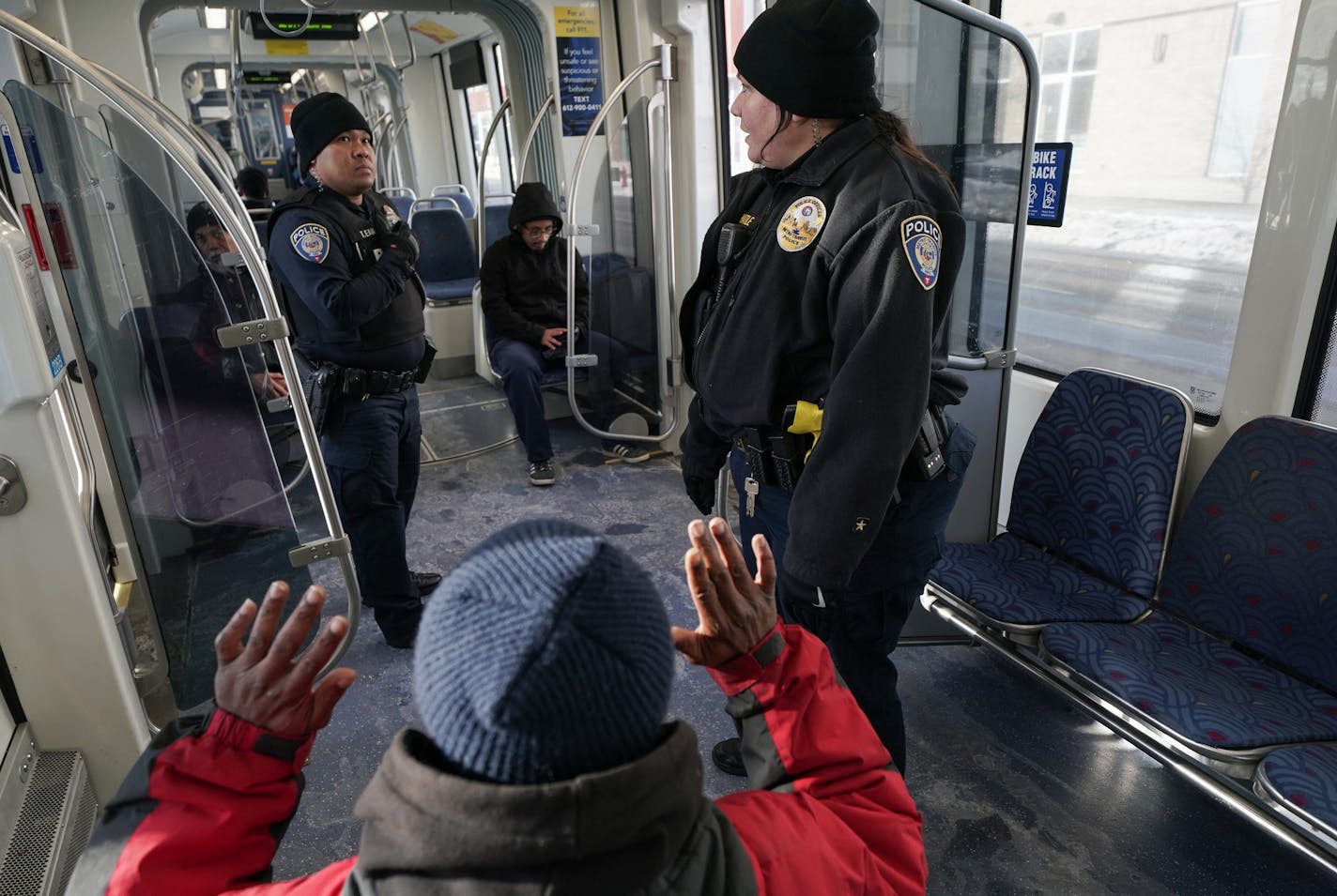 Metro Transit Police officers Erika Hatle and Tommy Eam questioned a man who was smoking a cigarette on the train. He explained another erratic passenger had caused him anxiety. ] MARK VANCLEAVE &#xa5; Metro Transit Police officers Tommy Eam and Erika Hatle patrolled Green Line trains in St. Paul on Tuesday, Dec. 10,2019. Metro Transit officer shift priories from fare enforcement to general safety as temperatures peak in the single digits.