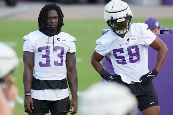Vikings linebacker Brian Asamoah II, left, with Jordan Hicks on Aug. 12, missed two weeks of practice with a shoulder injury. 